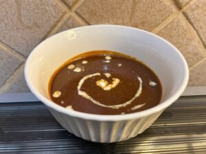 homemade caramel sauce in a white bowl placed on a counter