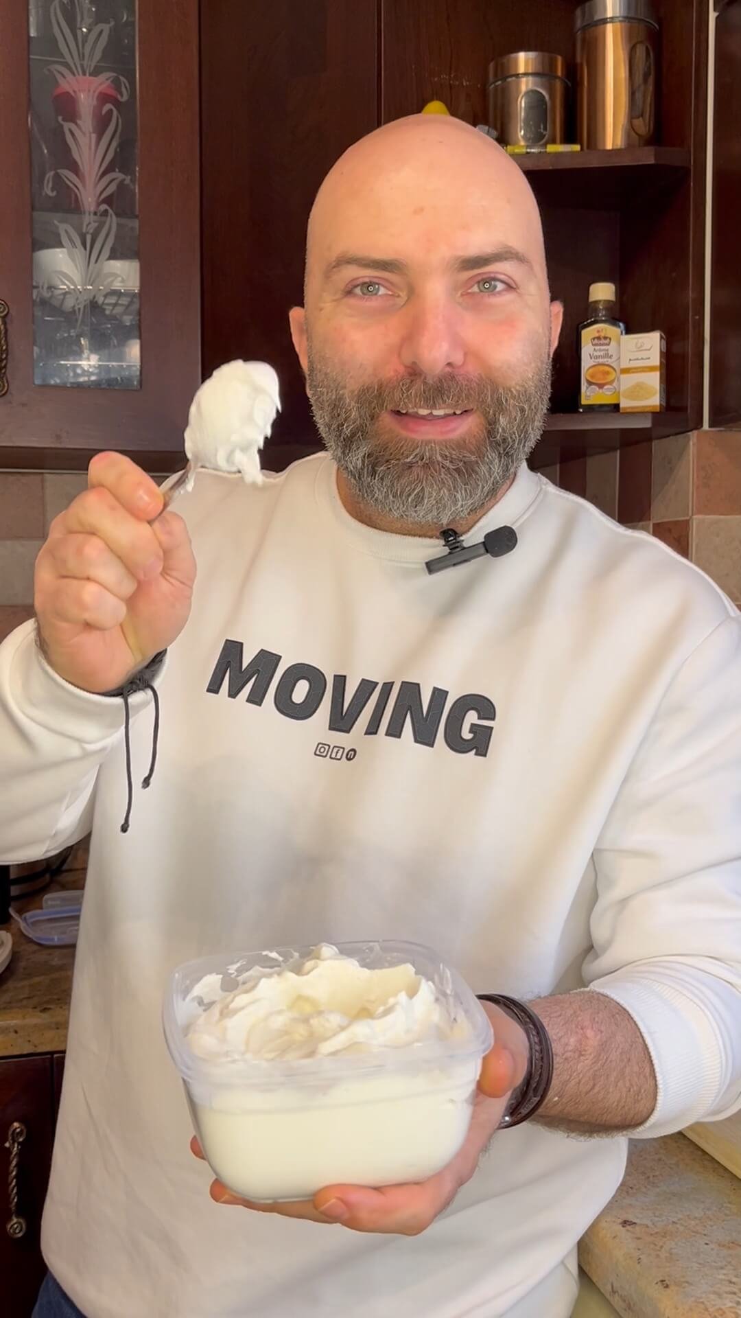 the chef holding a spoon with lebanese garlic dip