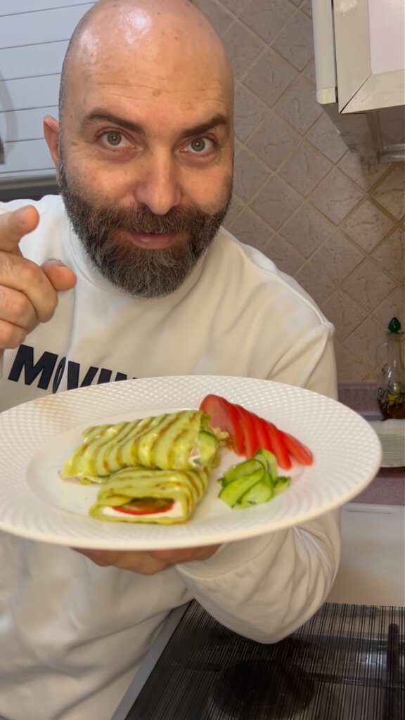 chef holding gluten free avocado egg wrap with labneh cucumber and tomato healthy wrap recipe