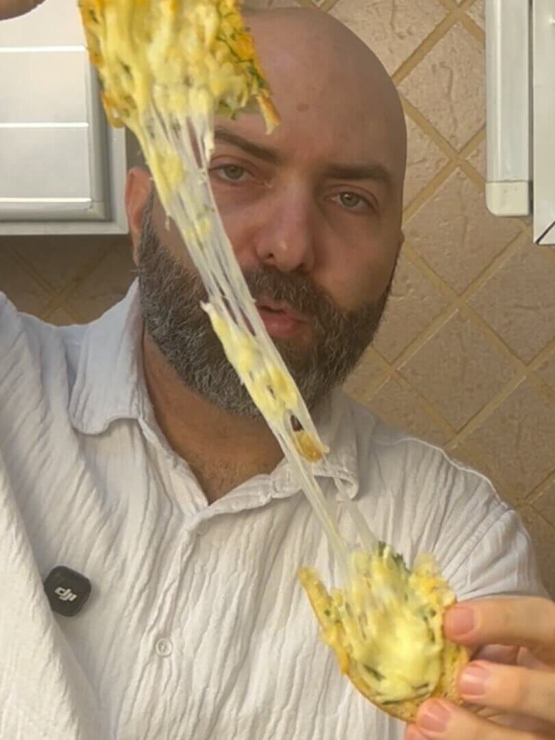chef holding a melting cheese bread