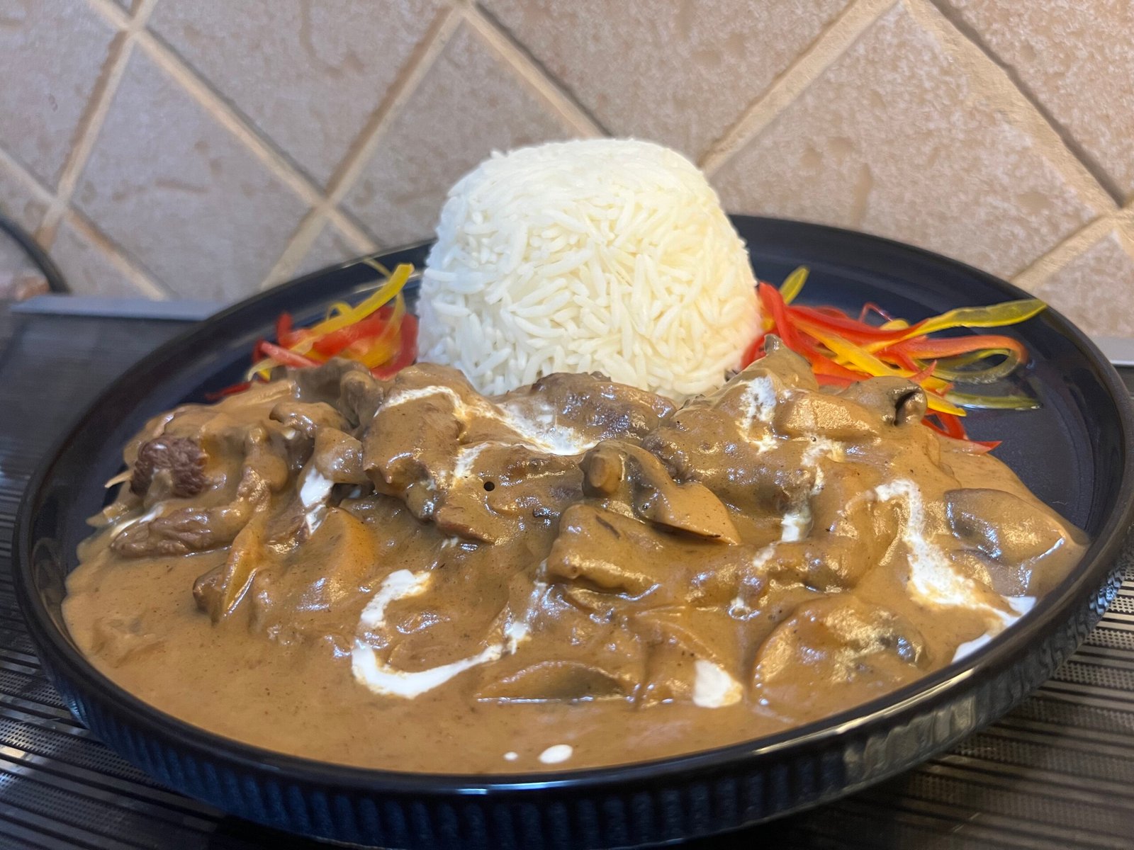 Creamy beef stroganoff with mushrooms and tender beef strips in a rich sauce served in a bowl