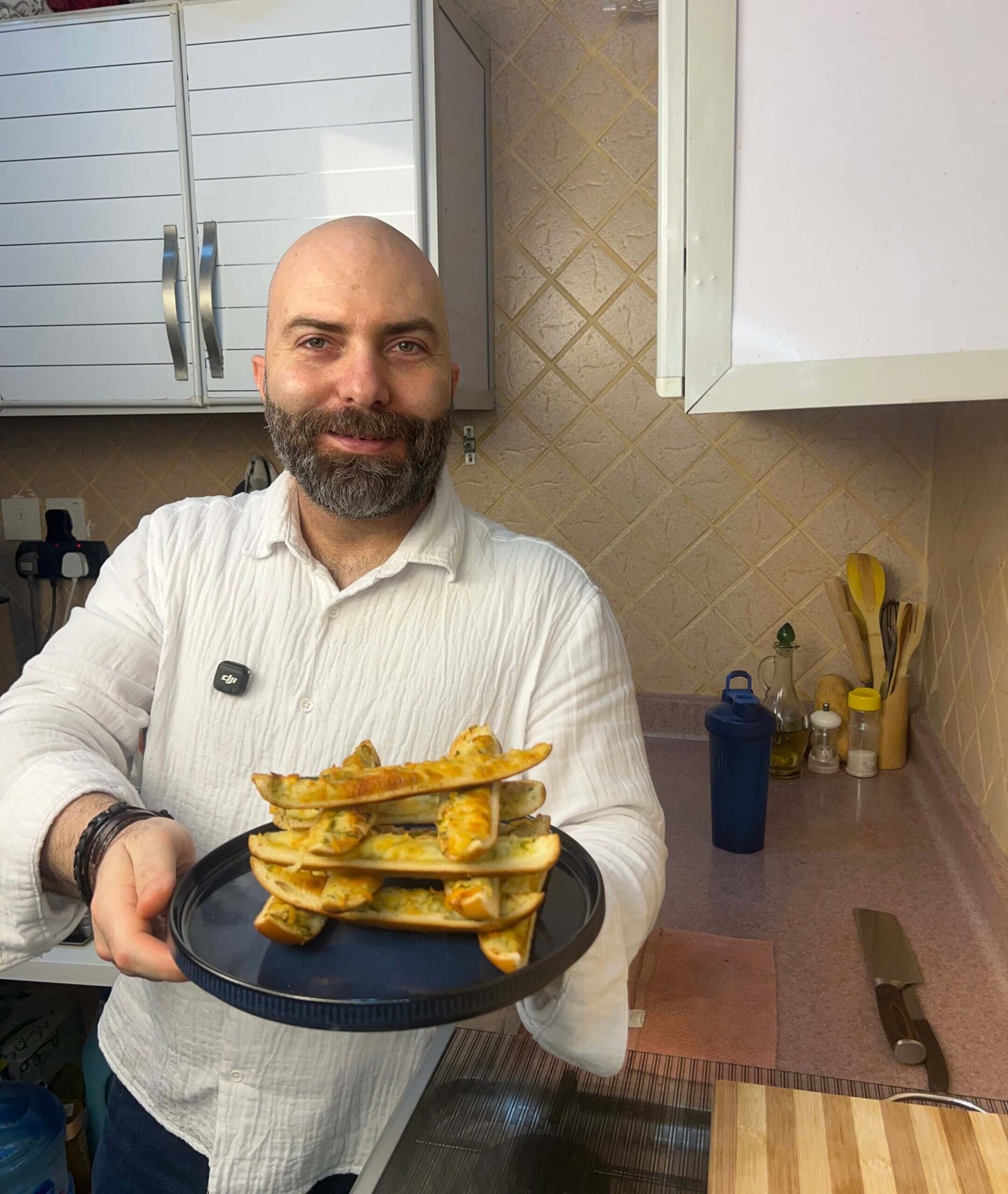 Chef Francois holding a plate of cheese garlic bread sticks