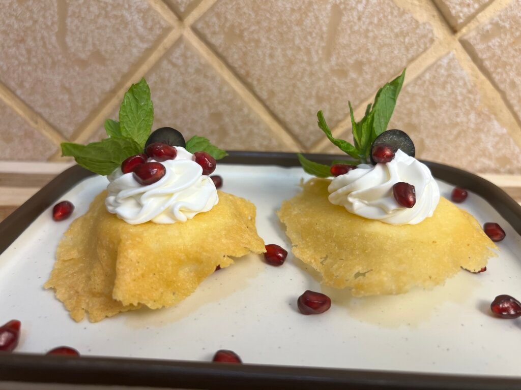 two pieces of Parmesan eggs placed in a white serving dish