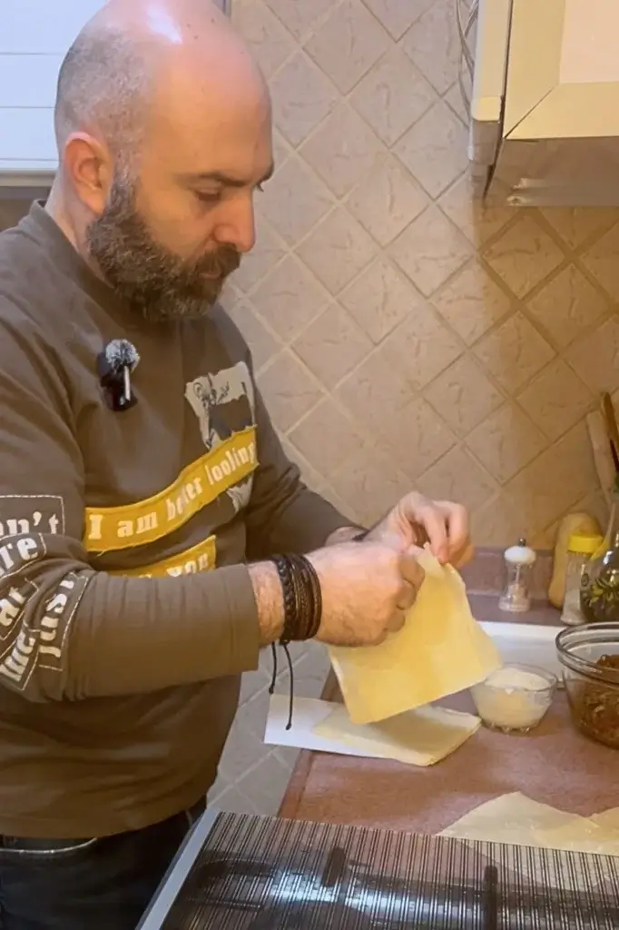 Chef preparing spring roll wrappers in a home kitchen before rolling crunchy spring rolls
