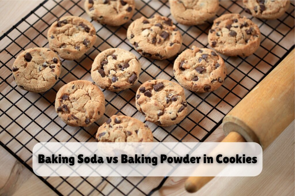 Baking soda vs baking powder in cookies illustrated by freshly baked chocolate chip cookies cooling on a wire rack beside a rolling pin.