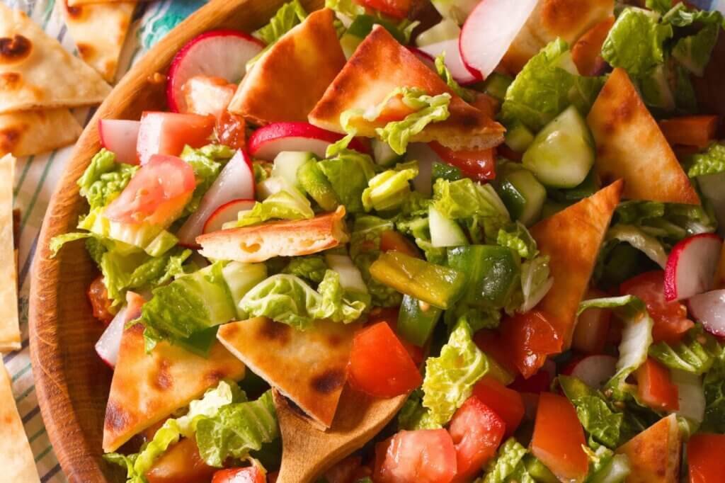 Fresh Lebanese fattoush salad made with crispy pita bread, lettuce, tomatoes, cucumbers, and radishes.