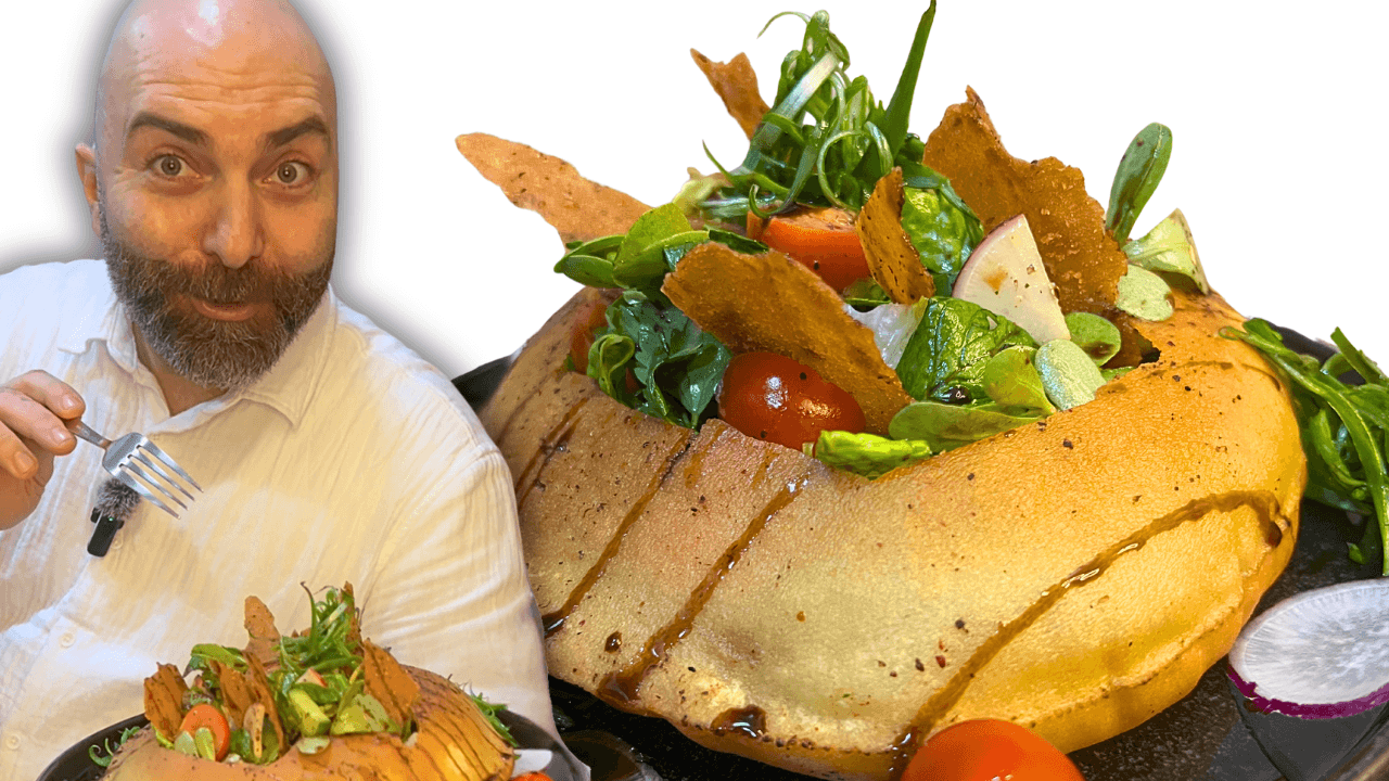 Chef François presenting authentic Lebanese fattoush salad served inside crispy Arabic bread.