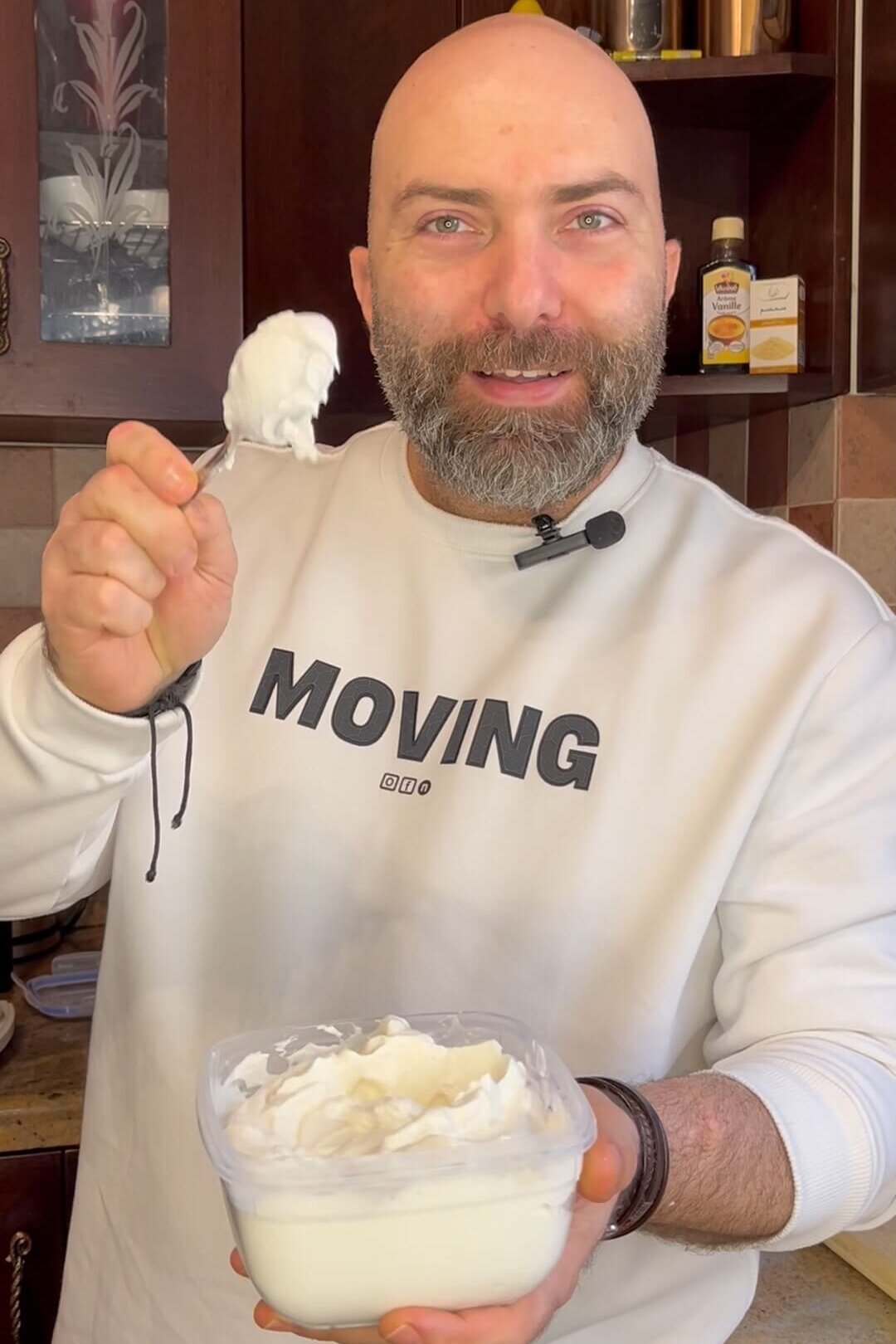 the chef holding a spoon with lebanese garlic dip