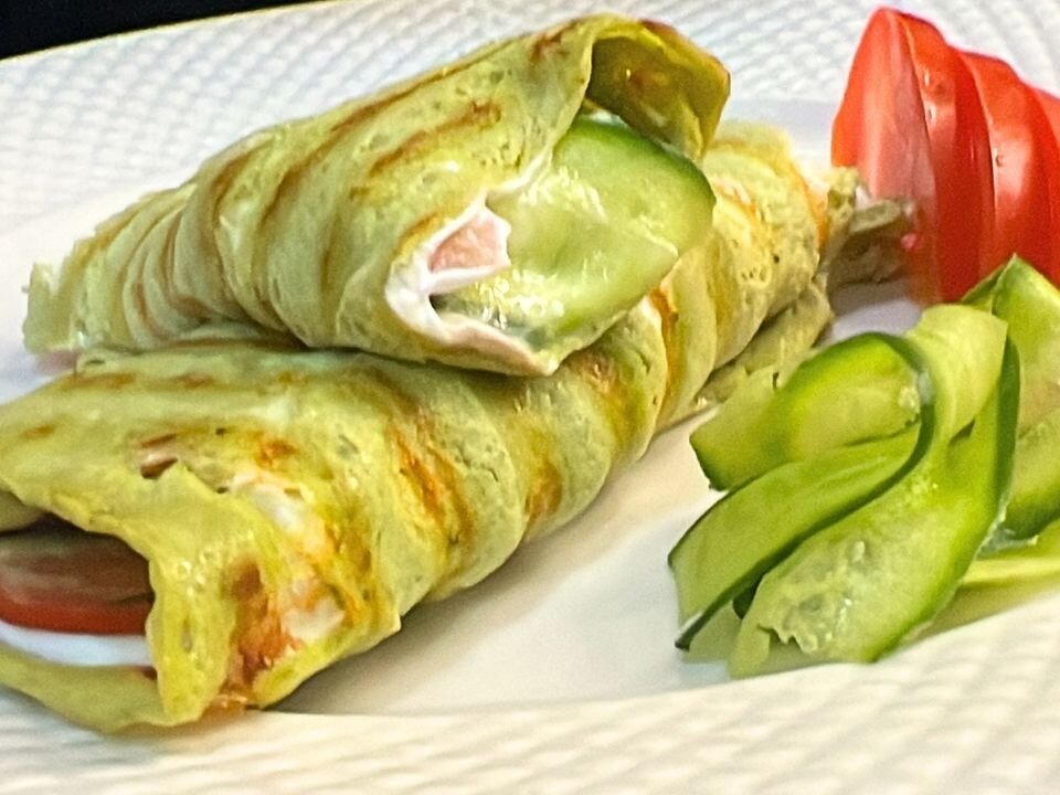 gluten free avocado egg wrap filled with labneh cucumber and tomato healthy low carb wrap