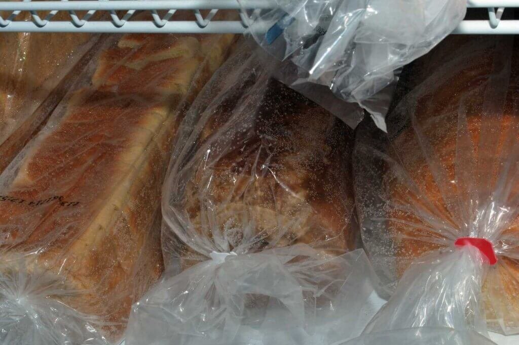 How to freeze food properly by storing bread loaves in airtight freezer bags to preserve freshness and prevent freezer burn.