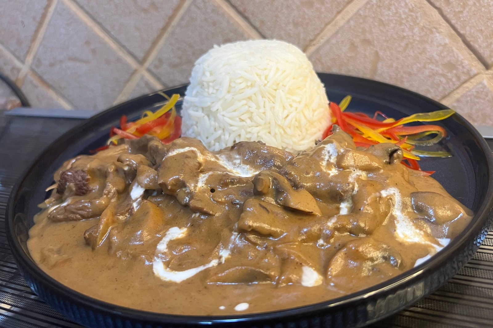 Creamy beef stroganoff with mushrooms and tender beef strips in a rich sauce served in a bowl