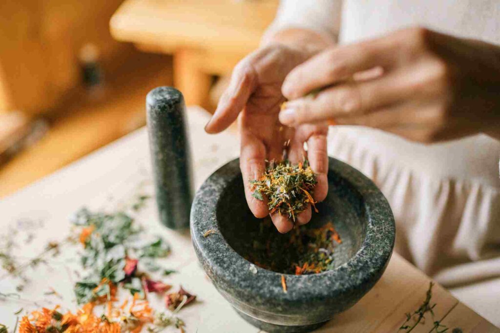 How to season foods by a colorful mixture of dried herbs and spices with a stone mortar and pestle.