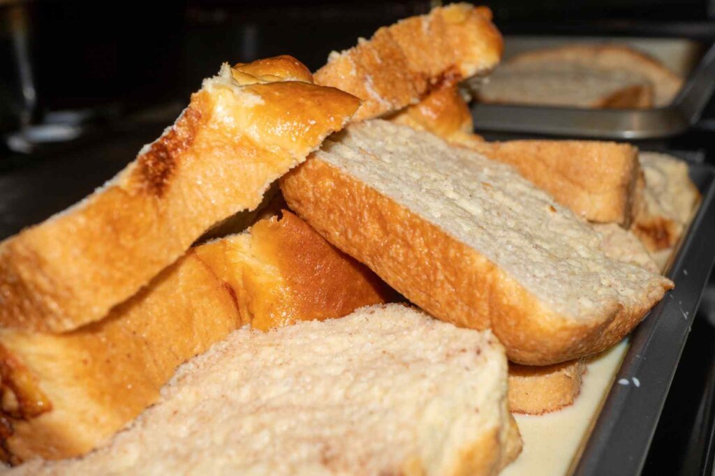 Thick slices of brioche bread prepared for making homemade French toast or pain perdu.