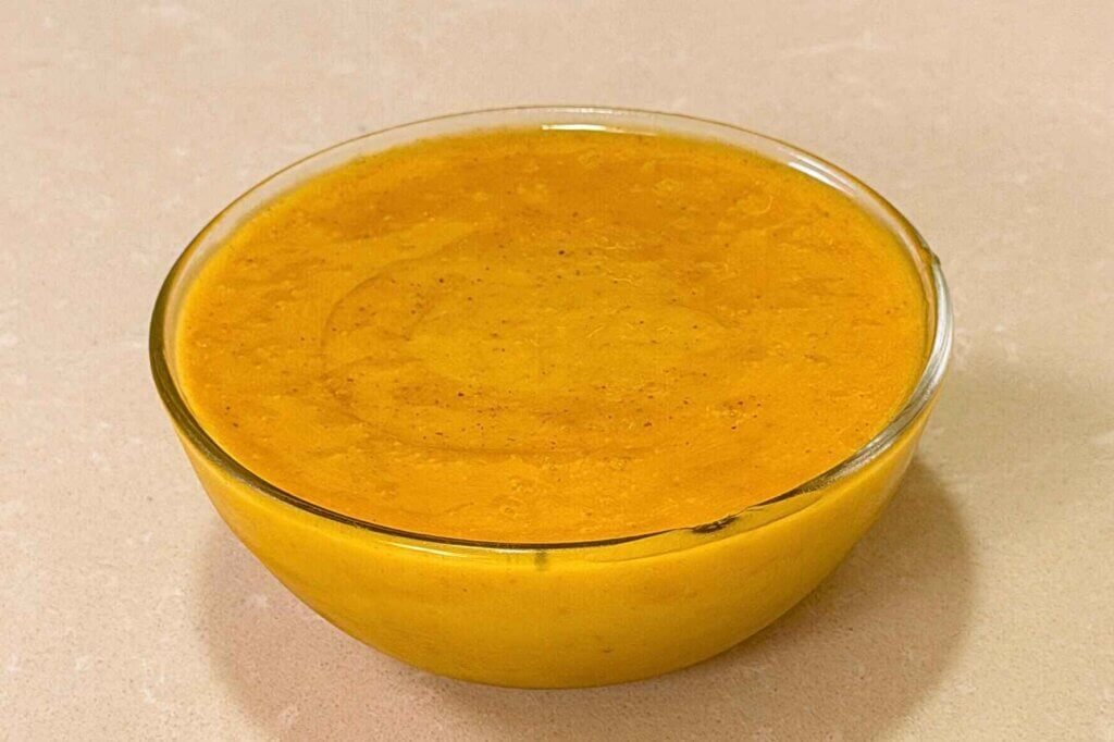 Homemade honey mustard sauce in a clear glass bowl