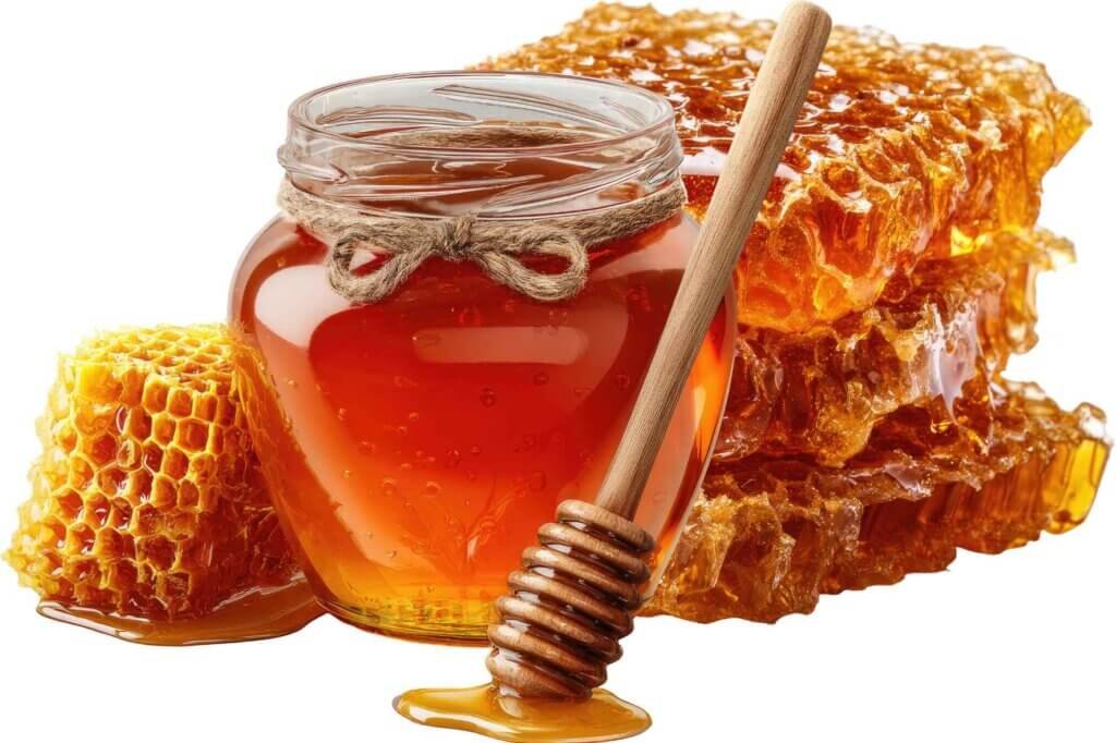 Jar of golden honey with honeycomb and a wooden honey dipper
