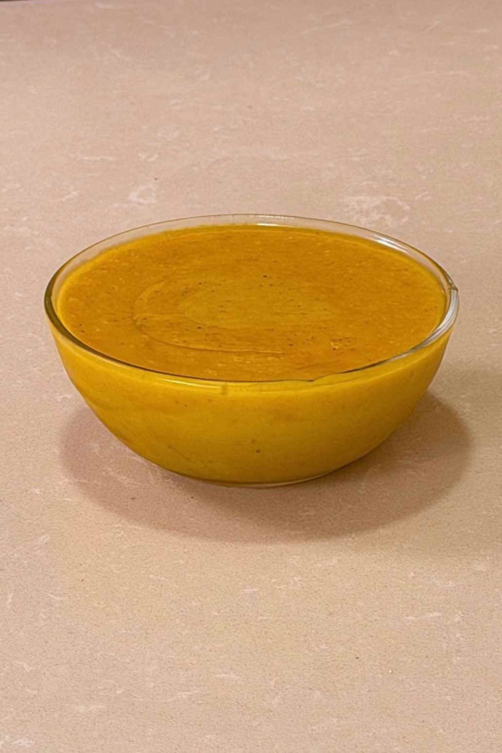 Homemade honey mustard sauce in a clear glass bowl